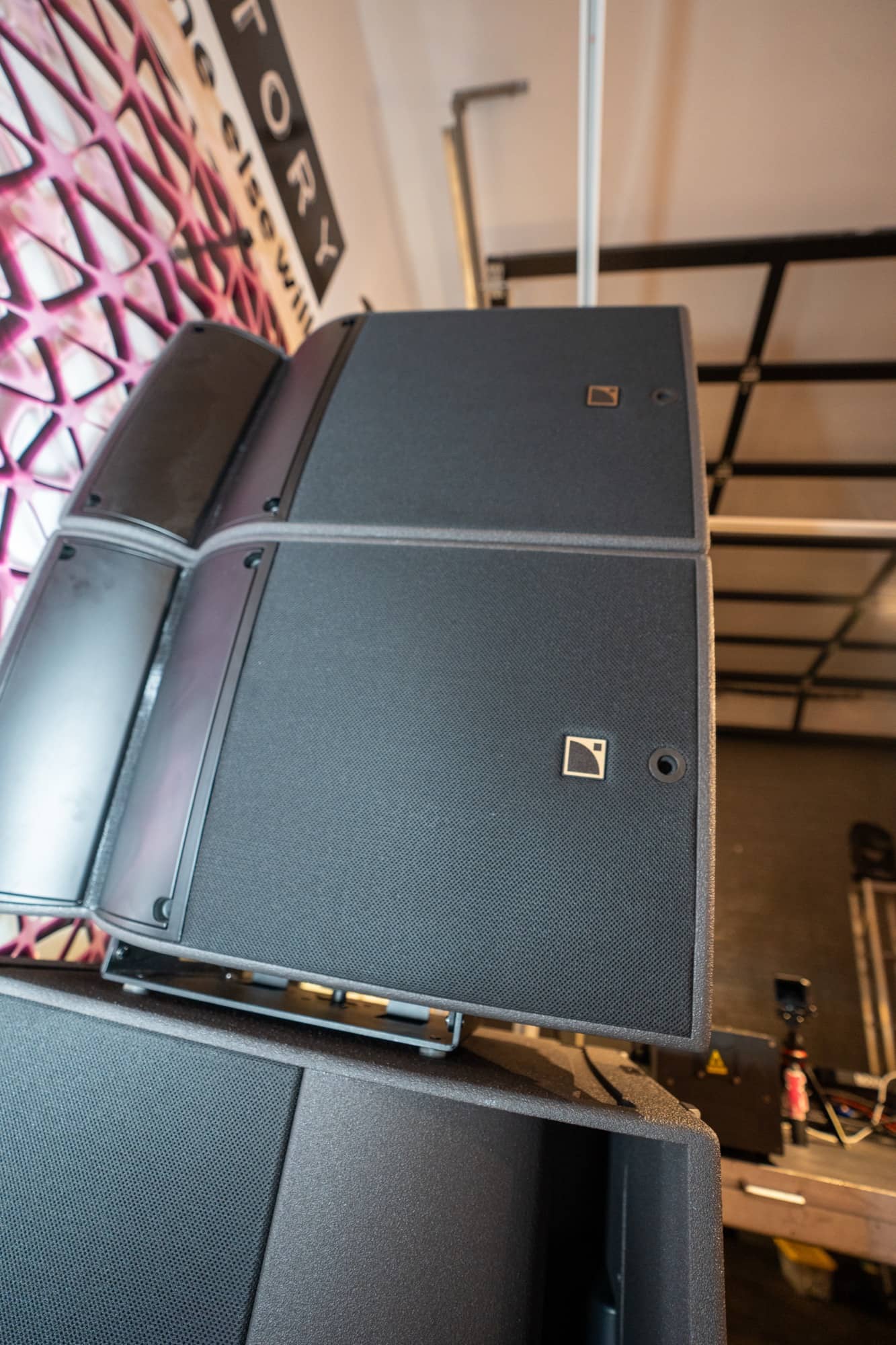 Speaker array angled into position against the venue wall