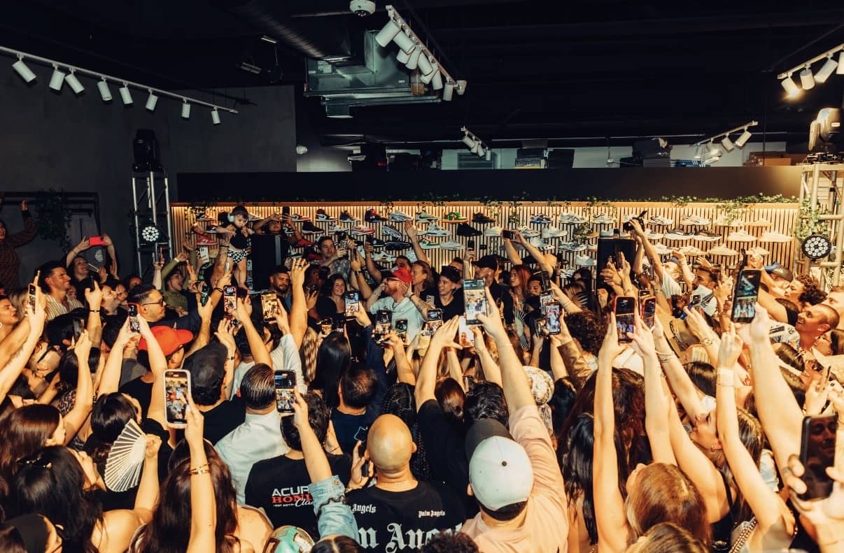 The showroom floor at capacity under the sneaker wall