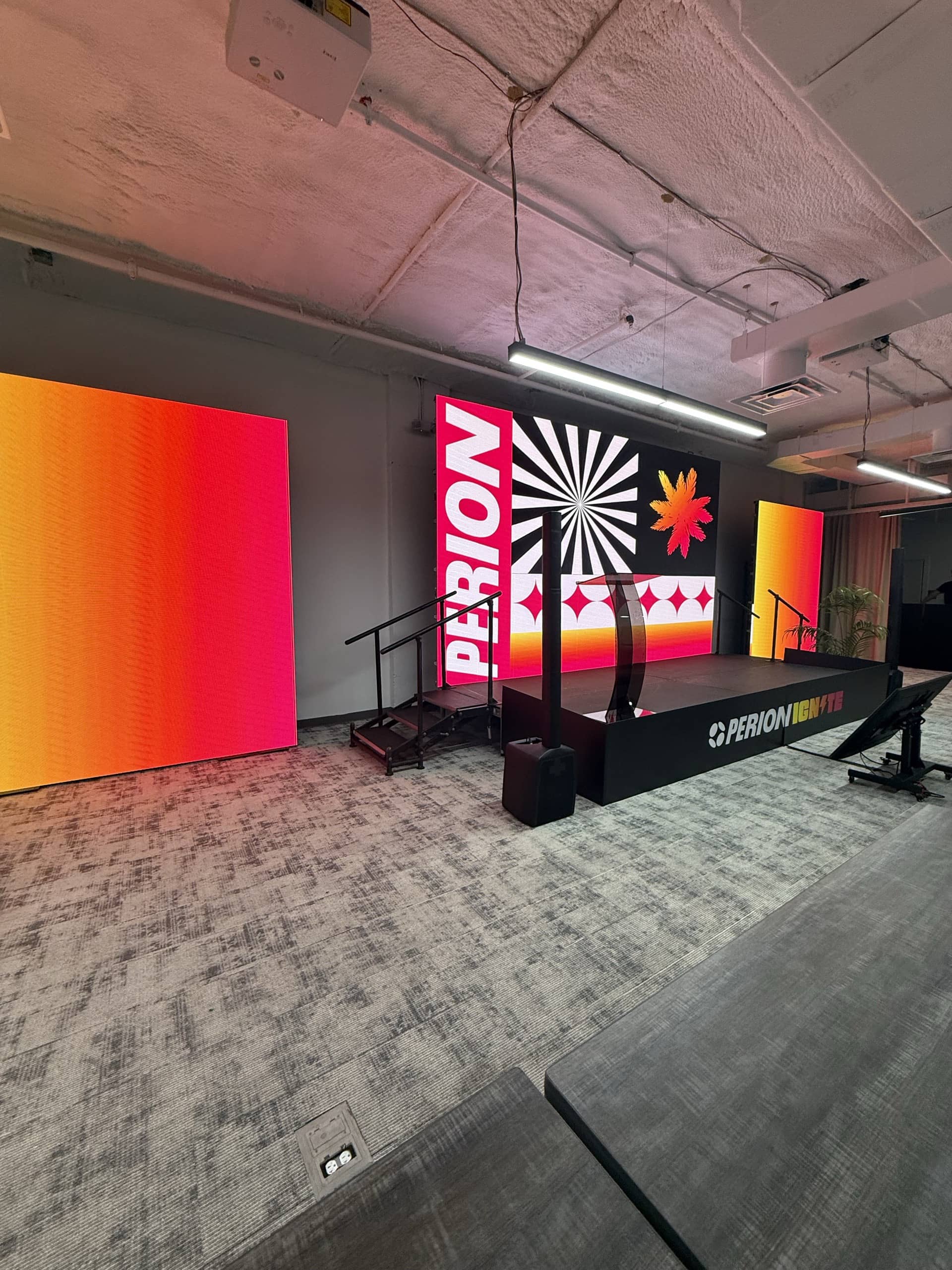 Corporate stage with branded LED wall, side screens, podium and stage deck, ready before doors